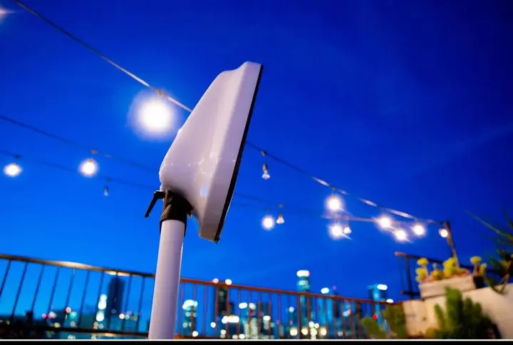 The booth on a rooftop under string lights