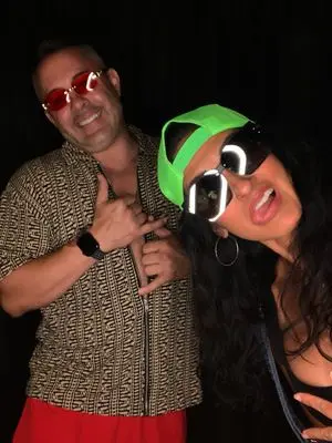 Two guests in oversized party sunglasses